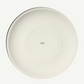 White ceramic plate with 'made in' text on a white background