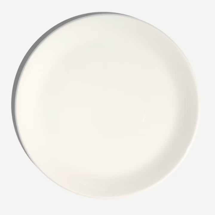 A plain white ceramic plate shown from a top-down view against a light gray background.