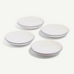 Four white plates with blue rims on a white background