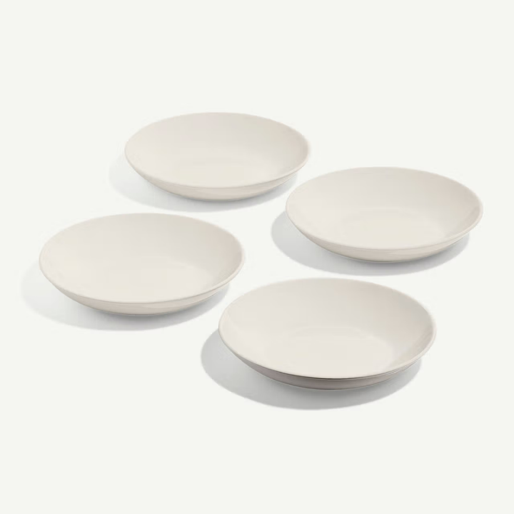 Four white ceramic bowls on a light gray background