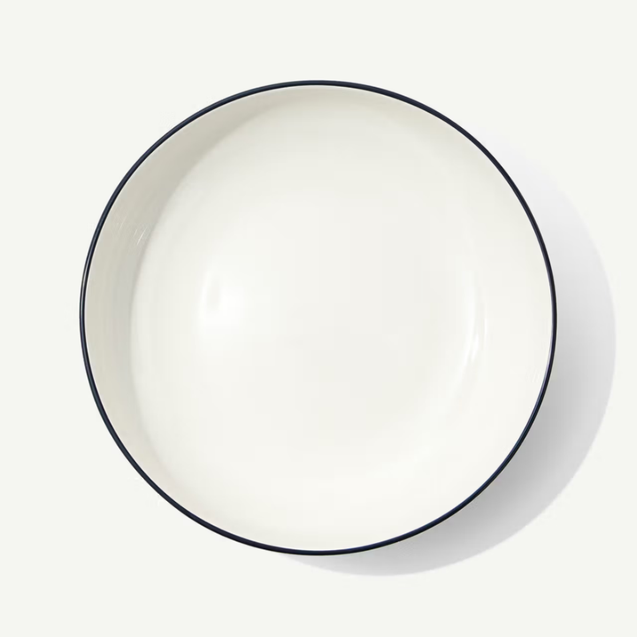 White plate with a black rim on a white background