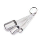 Three stainless steel measuring spoons nested together on a white background, attached to a metal key ring. The spoons are engraved with measurements including 1 tbsp (15 ml), 1 tsp (5 ml), and 1/4 tsp (2.