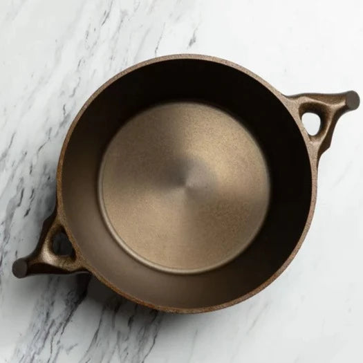 This 3.5 quart Cast Iron Dutch Oven’s interior is machined smooth all the way up the sides, so you can transition from searing to roasting with optimal ease. Included is a self-basting lid topped with a glistening brass knob which also fits the 9” Skillet. The handles on this gorgeous piece of functional art have been modeled after a cherry tree branch and the formed for optimal hand comfort.  