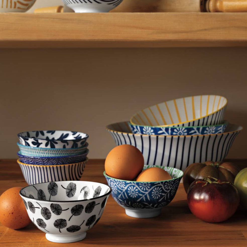 Set of decorative bowls with different patterns on a wooden surface.