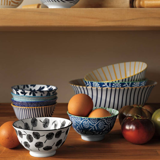 Set of decorative bowls with different patterns on a wooden surface.