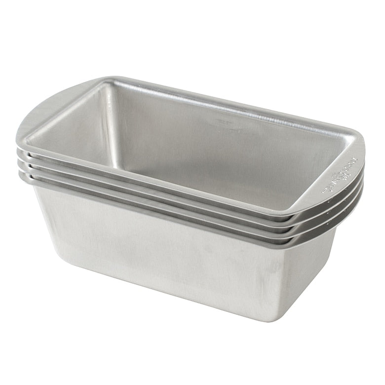 Stack of metal loaf pans on a white background