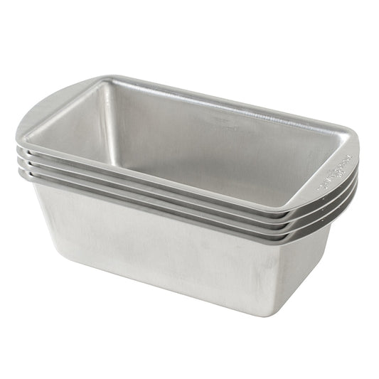 Stack of metal loaf pans on a white background