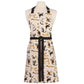 A cream-colored kitchen apron with a black waist tie and neck strap, featuring an all-over print of various cat illustrations in black, brown, and gray. The apron is displayed on a white mannequin torso against a plain white background.