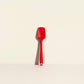 Red spatula on a beige background