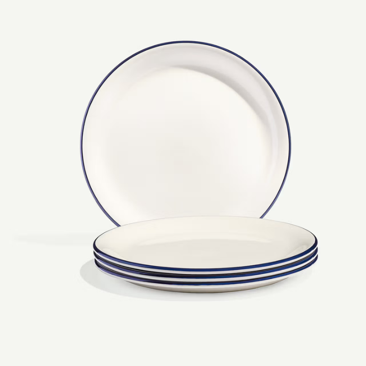 Set of white plates with blue rims and stripes on a white background