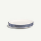 A stack of five round white ceramic plates with thin dark blue stripes along the rims, set against a clean off-white background.