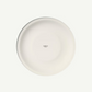 A minimalist white ceramic plate with a small 'made in ITALY' print in the center, shown from a top-down view on a light off-white background.