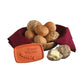 Bread warmer with bread rolls and a basket of bread on a white background