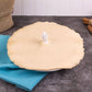 Pie with a Baking Pie Bird on a table with a blue cloth and cinnamon sticks.