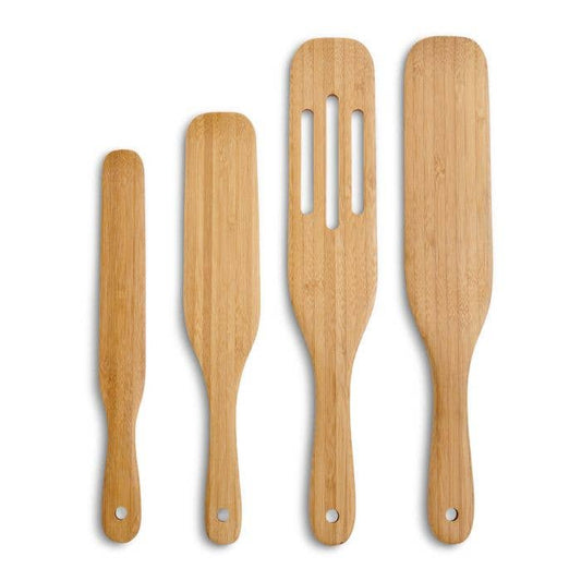 Set of four wooden spatulas with different designs on a white background