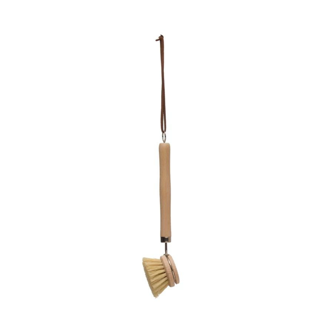 Creative Co-Op's Dish Brush 9 inches long hanging from a leather strap