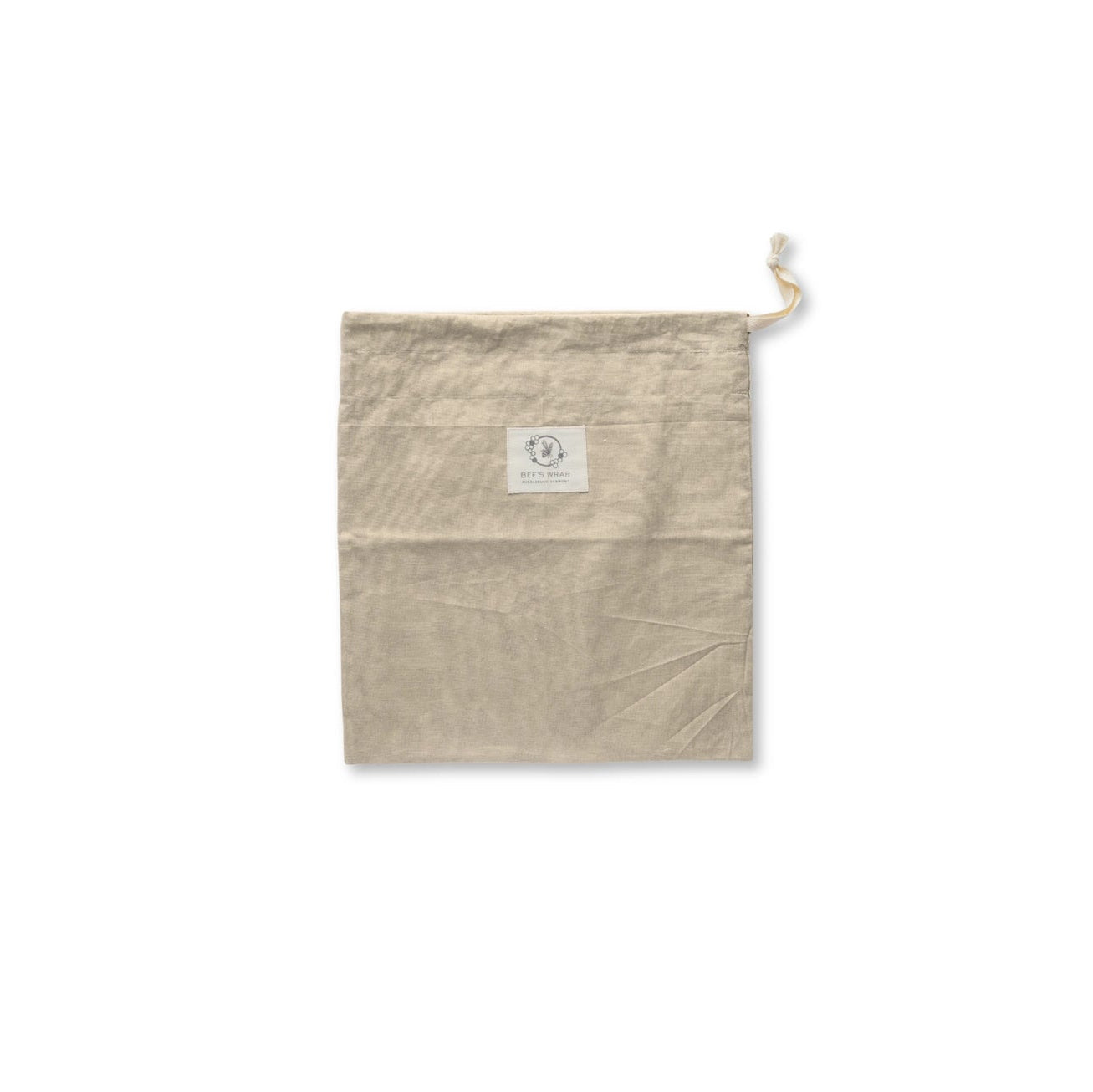 A light beige cotton drawstring pouch with a small white square label on the front, shown against a plain white background.