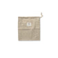 A light beige cotton drawstring pouch with a small white square label on the front, shown against a plain white background.