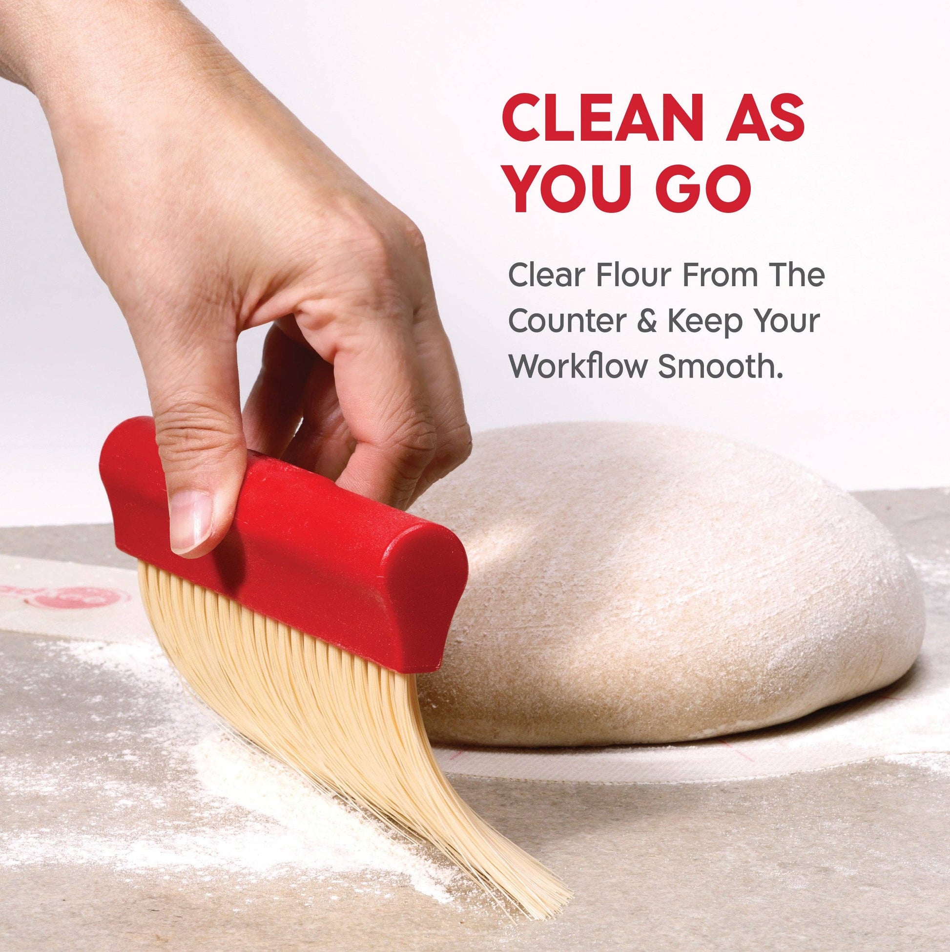 Hand using a red brush to clear flour from a surface with text promoting efficient cleaning.