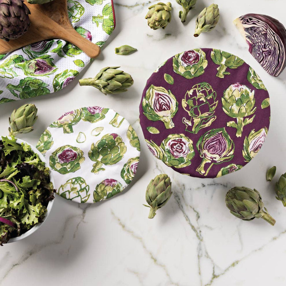 Decorative plates with artichoke pattern on a marble surface
