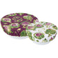 Two round fabric covers with artichoke pattern on a white background