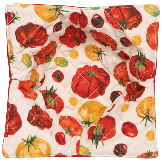 Quilted pot holder with tomato and pepper pattern on a white background