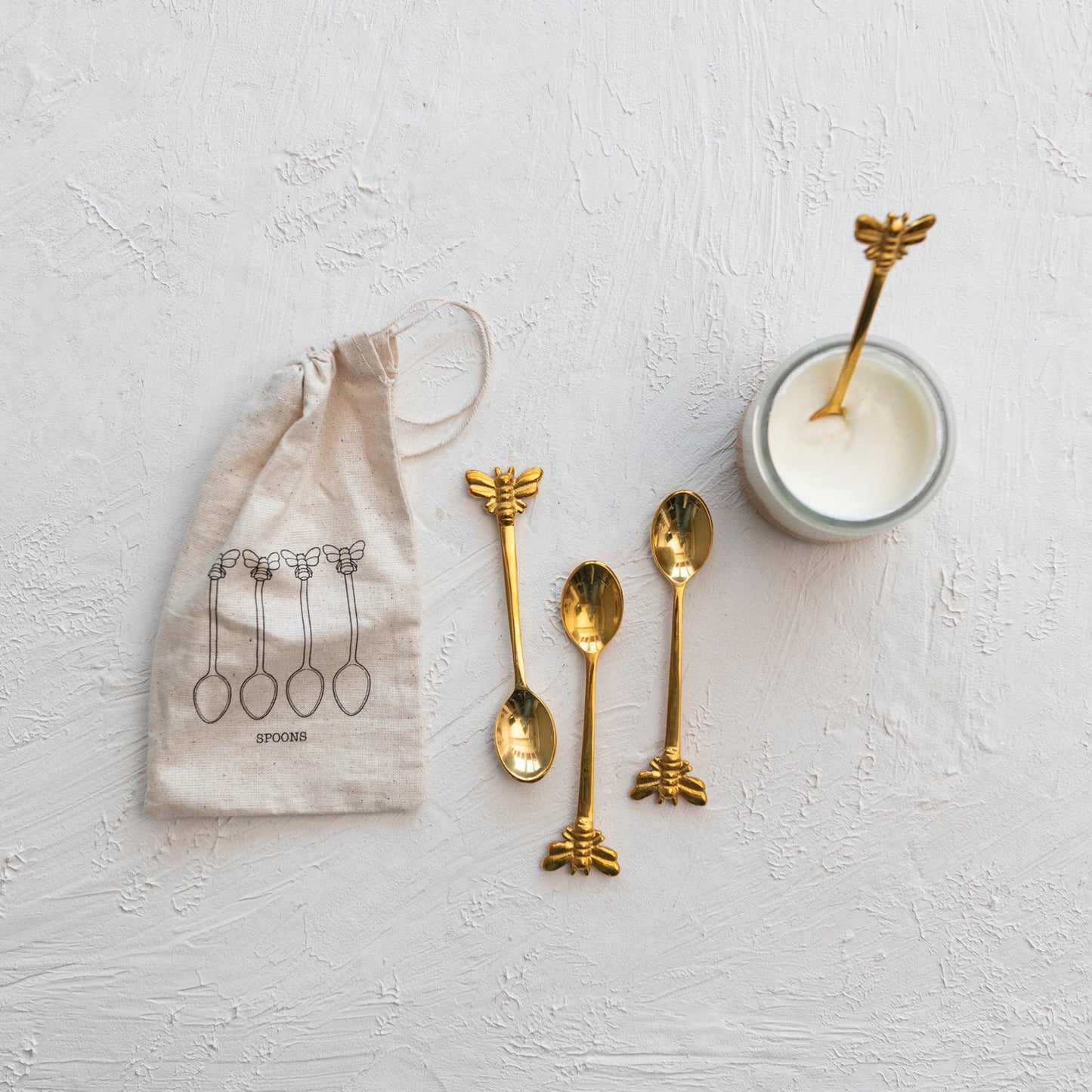 Add a touch of charm to your gatherings with this beautifully crafted set of brass spoons, featuring whimsical bee-shaped handles in a stylish brass finish. Inspired by cozy cottage aesthetics, these versatile spoons are perfect for serving, stirring, or simply elevating your table decor. Measuring 4.5” in length, they are made of durable brass and should be hand washed only to maintain their elegant finish.