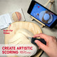 Person scoring bread with a knife, using a phone app for guidance on a concrete surface.