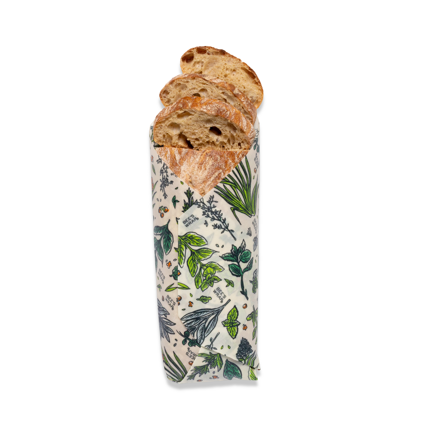 Bread loaf wrapped in a patterned paper with green leaf design on a white background