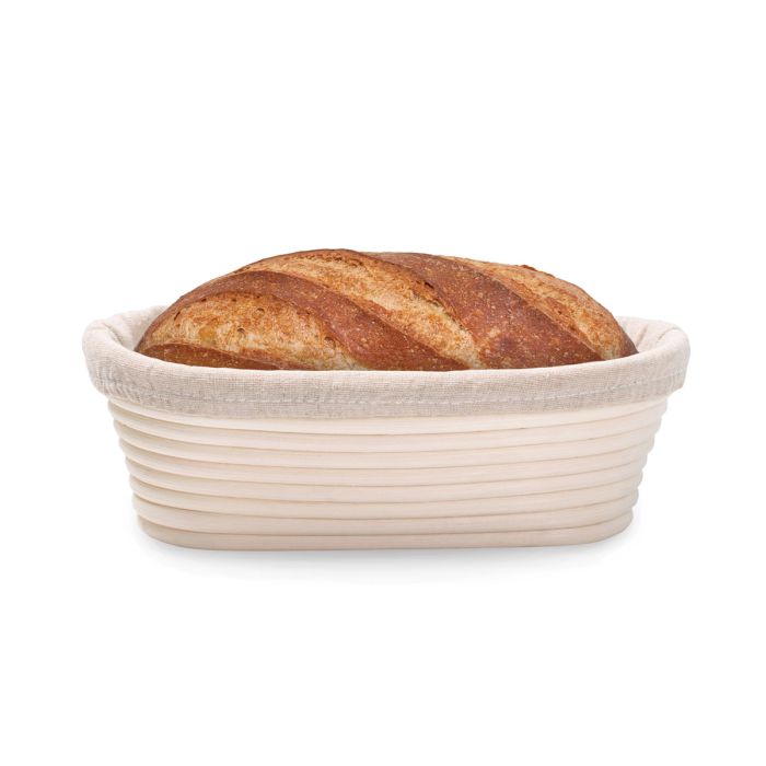 Loaf of bread in a woven basket on a white background