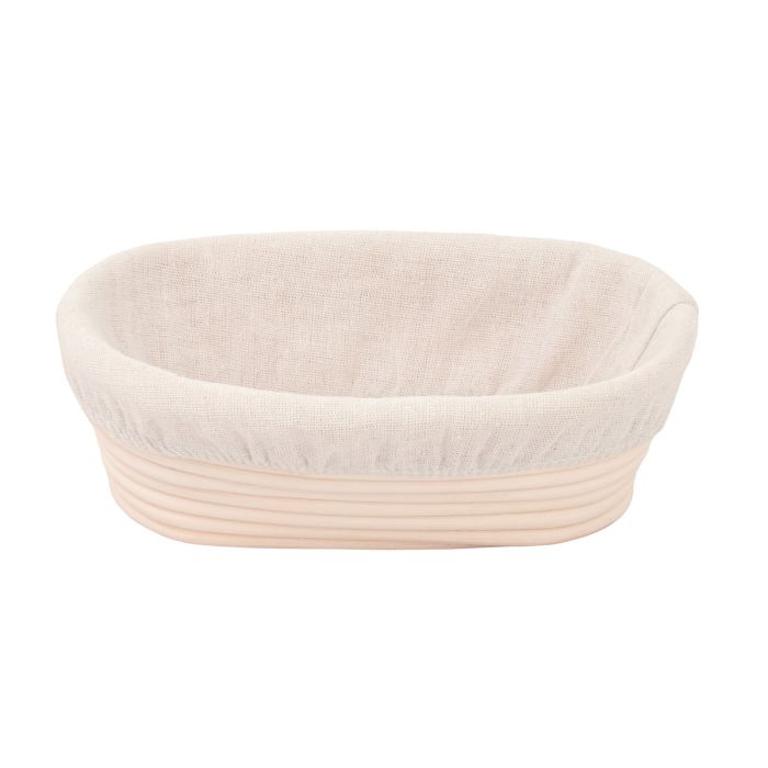 Round bread proofing basket with beige interior and rim on a white background
