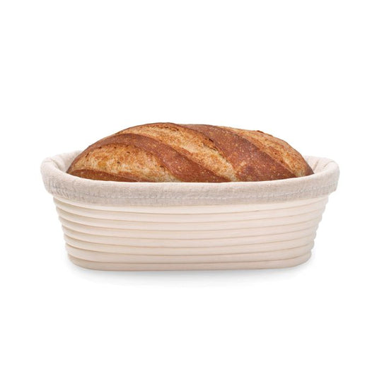 Loaf of bread in a woven basket on a white background