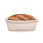 Loaf of bread in a woven basket on a white background