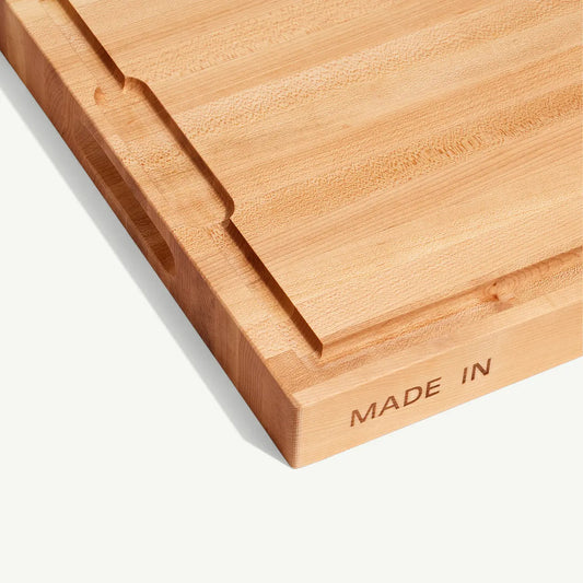 Wooden cutting board with 'MADE IN' engraving on a white background