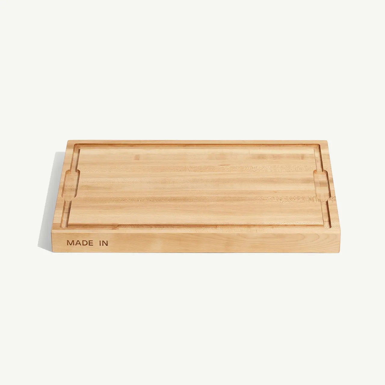 Cutting board with 'MADE IN' text on a white background