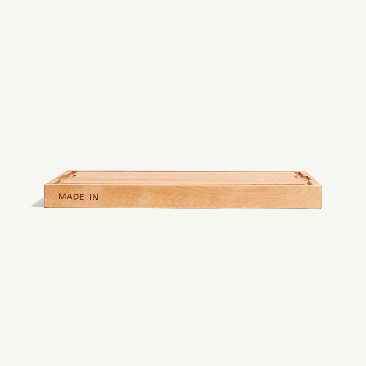 Cutting board with 'MADE IN' text on a white background
