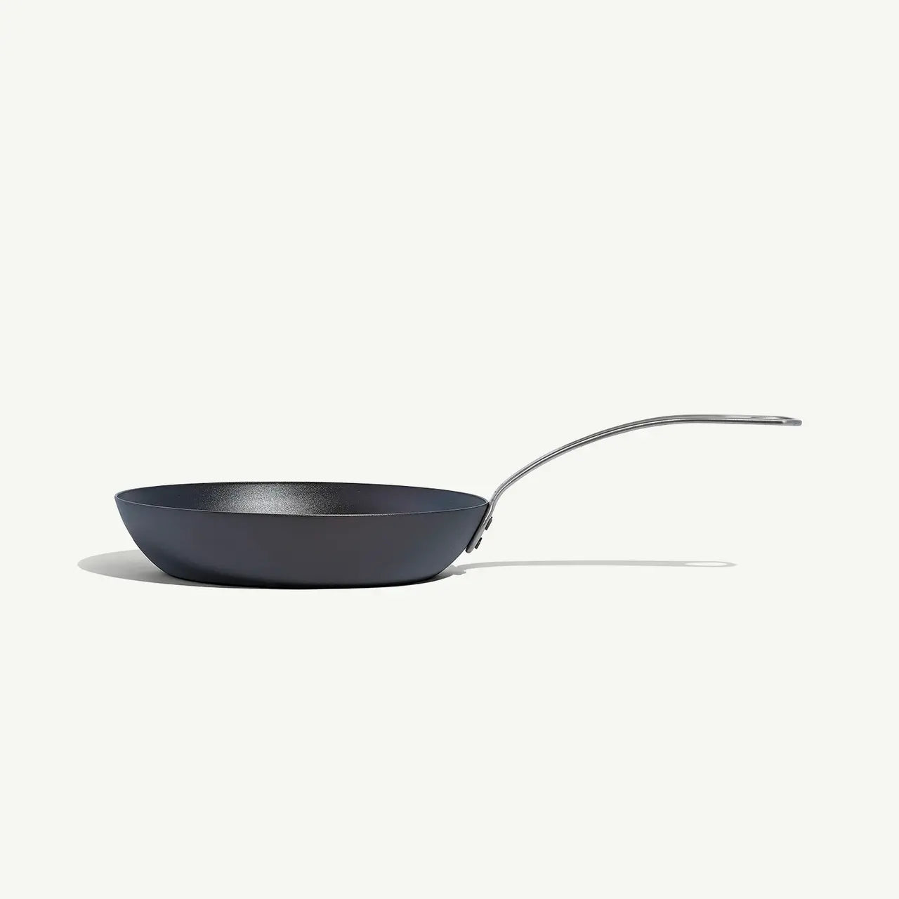 An 8-inch carbon steel frying pan with a gray surface and a stainless steel handle, pre-seasoned and ready for use on a white background.