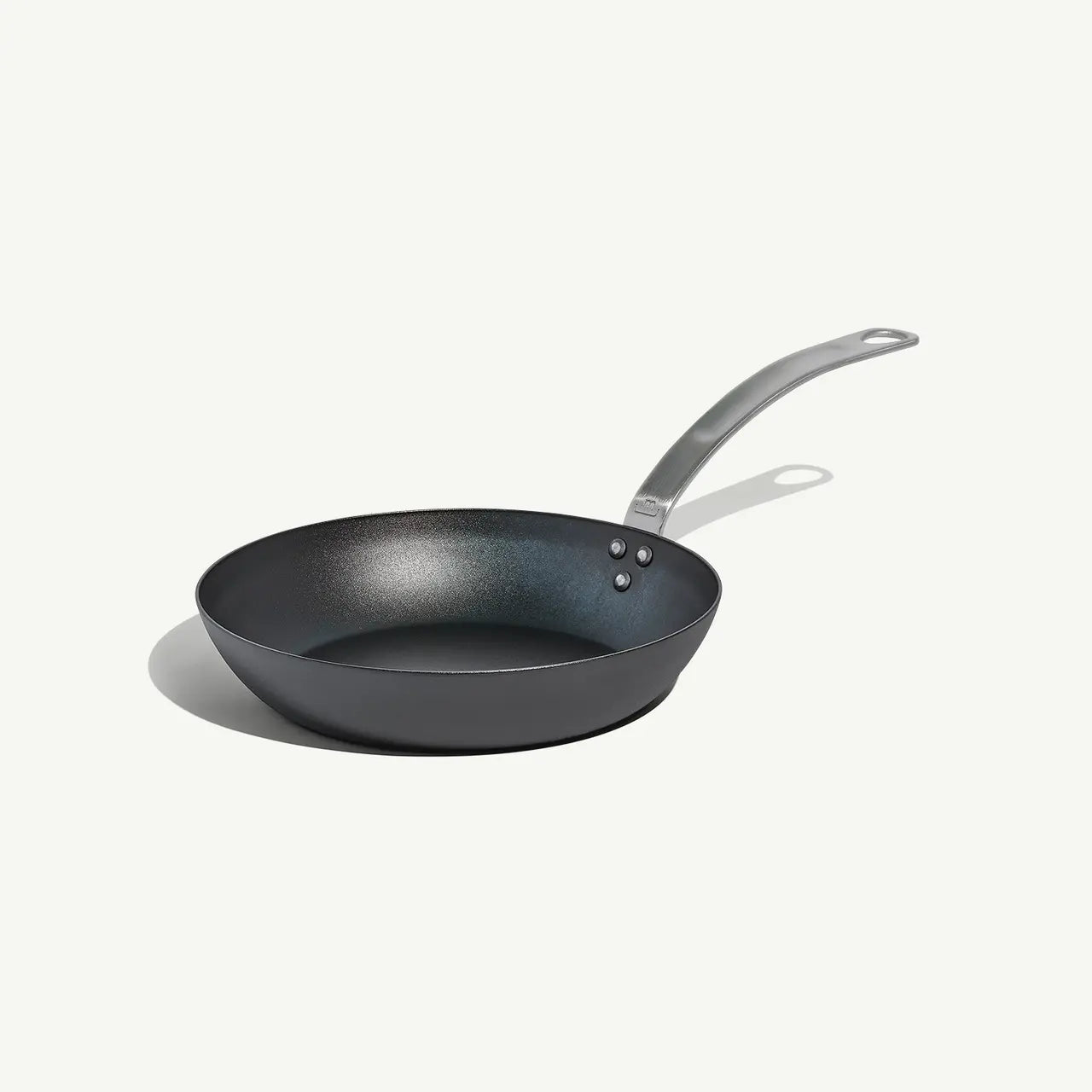 An 8-inch carbon steel frying pan with a gray surface and a stainless steel handle, pre-seasoned and ready for use on a white background.