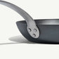 An 8-inch carbon steel frying pan with a gray surface and a stainless steel handle, pre-seasoned and ready for use on a white background.