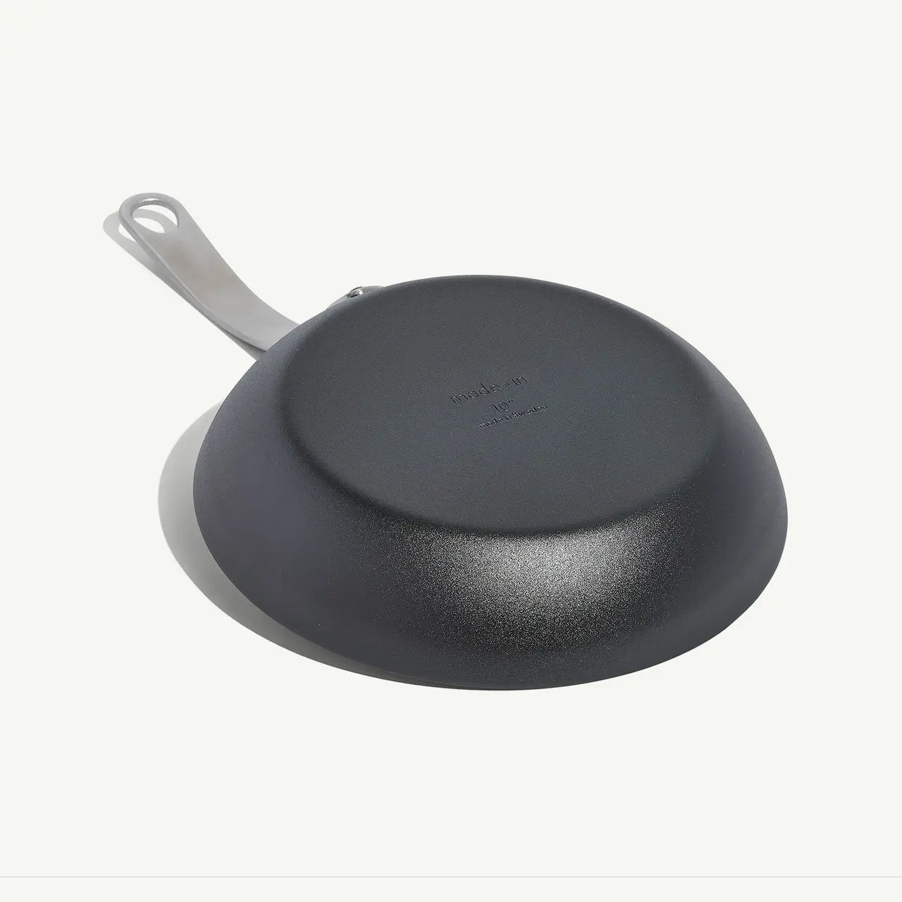 An 8-inch carbon steel frying pan with a gray surface and a stainless steel handle, pre-seasoned and ready for use on a white background.