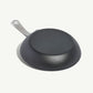 An 8-inch carbon steel frying pan with a gray surface and a stainless steel handle, pre-seasoned and ready for use on a white background.
