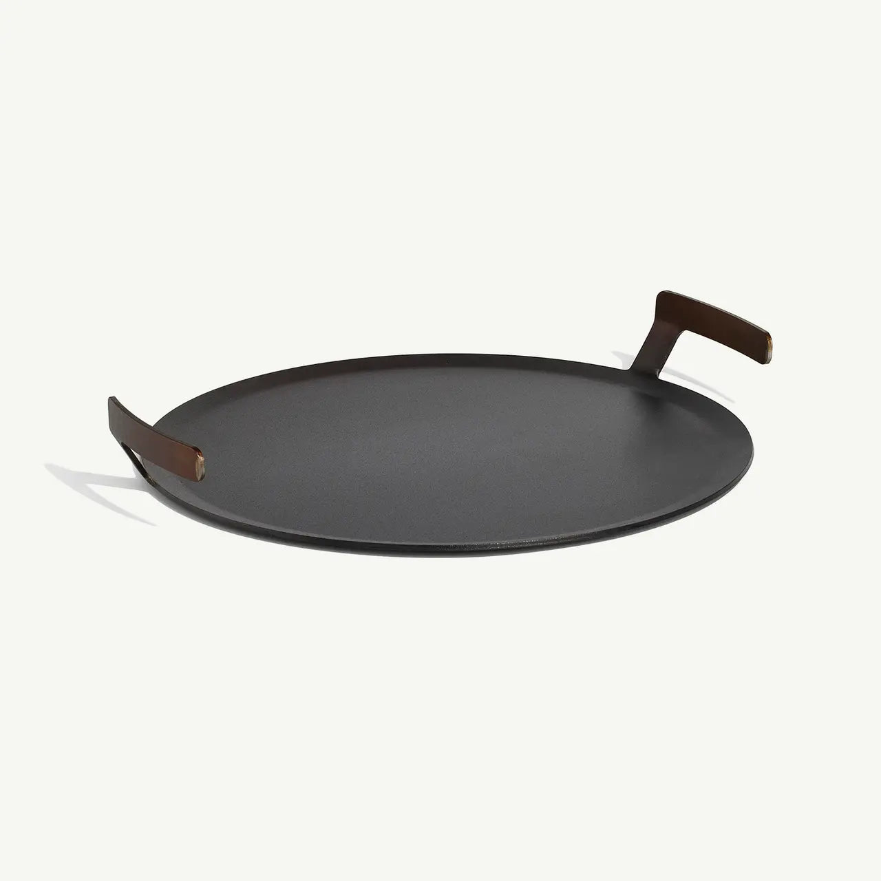 Black round tray with wooden handles on a white background