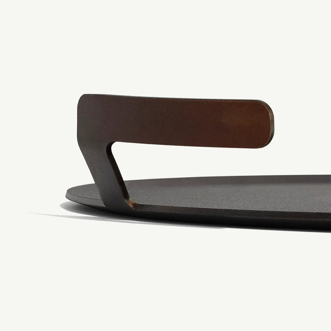 Metallic object with a handle on a white background