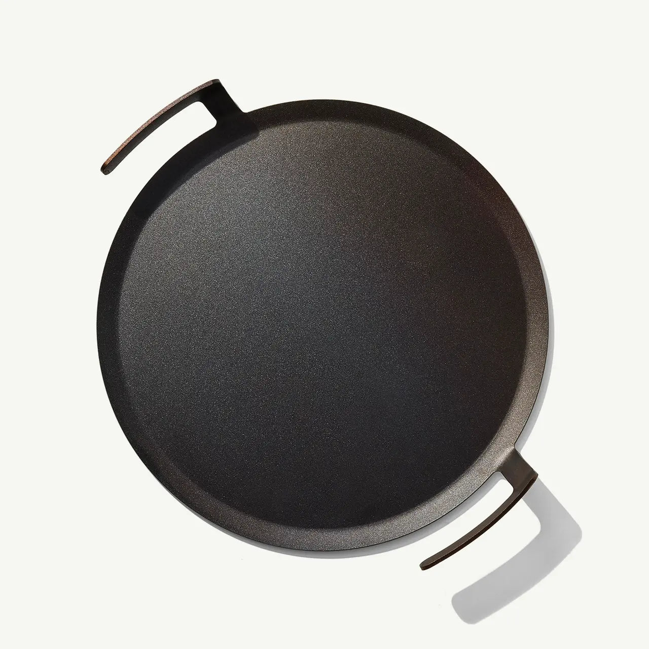 Black cast iron skillet on a white background