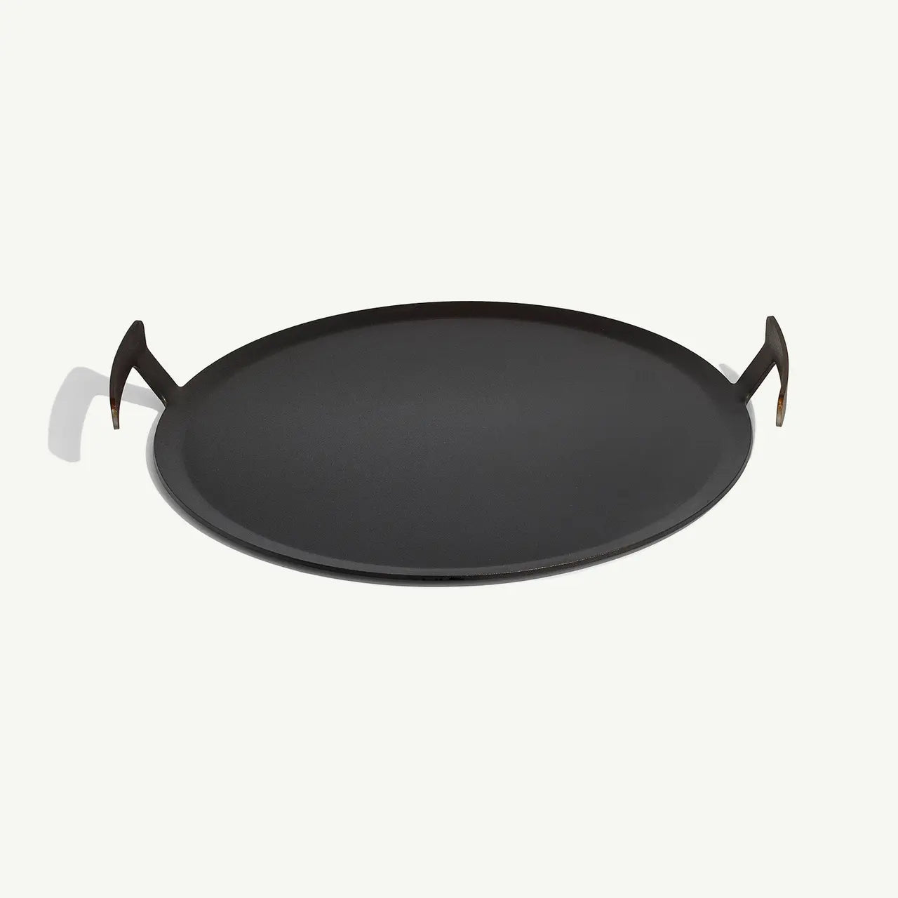 Black round tray with handles on a white background
