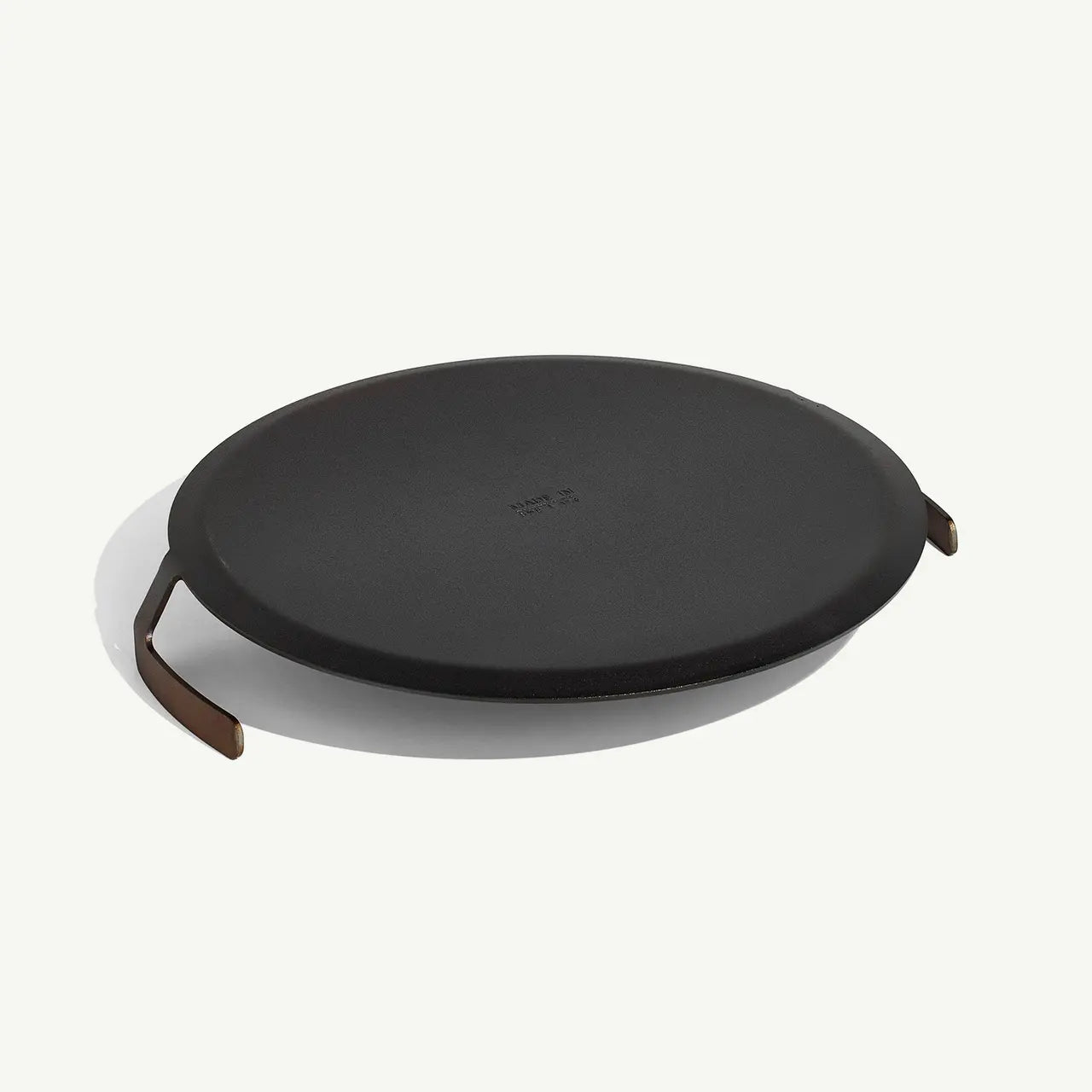 Black round lid with handles on a white background