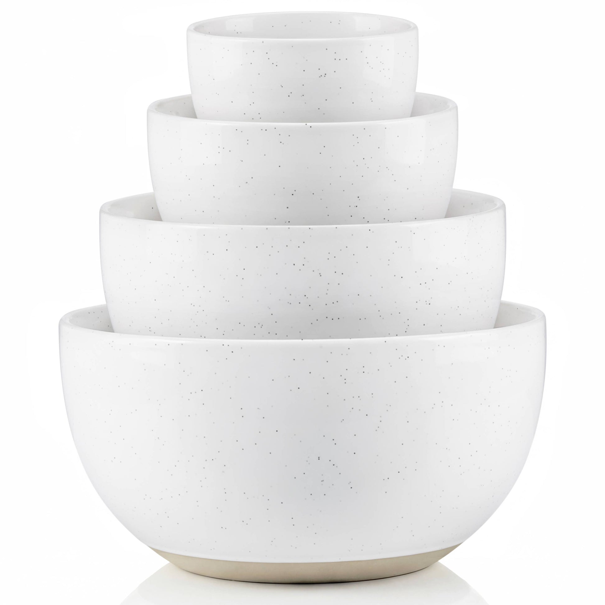 Set of four white ceramic bowls of different sizes stacked on a white background