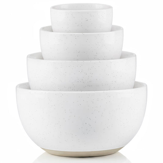 Set of four white ceramic bowls of different sizes stacked on a white background