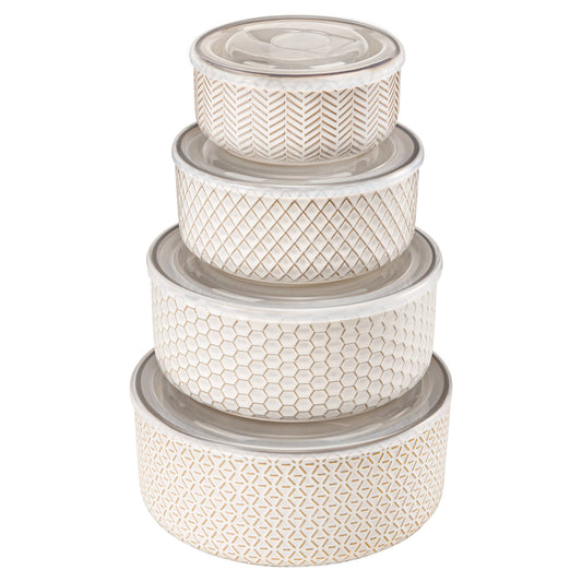 Set of four decorative storage containers with geometric patterns on a white background