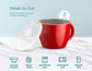 A red ceramic mug with a clear lid, shown on a white marble surface against a light blue background. Text reads 'Meals to Go!' and '2 MUGS,' with feature icons below for durable ceramic, matte finish, dishwasher safe, microwave safe, and freezer safe.